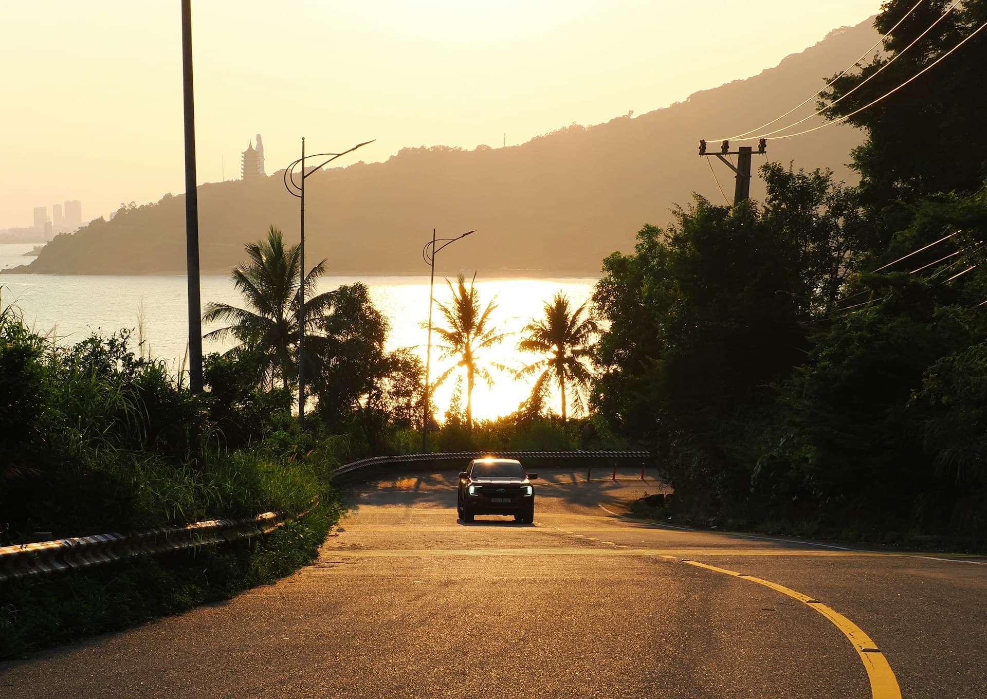 Scenic coastal Karnataka highway at golden hour alongside the Arabian Sea - RV Tours & Travels